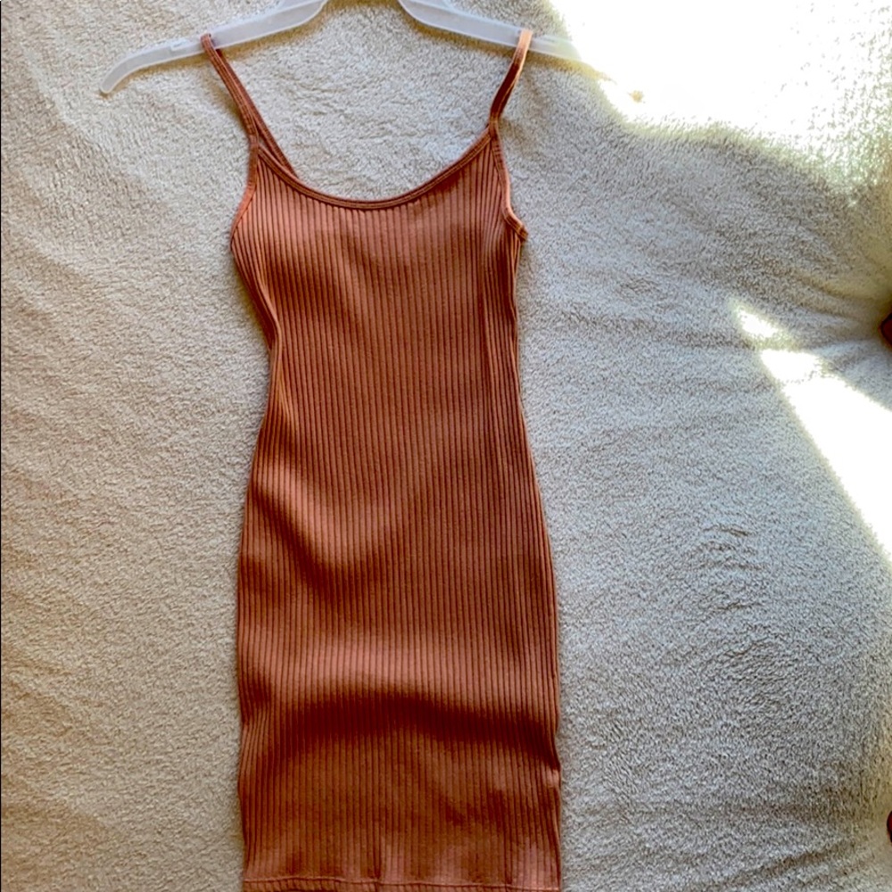 A beige, spaghetti strapped, tight, striped dress